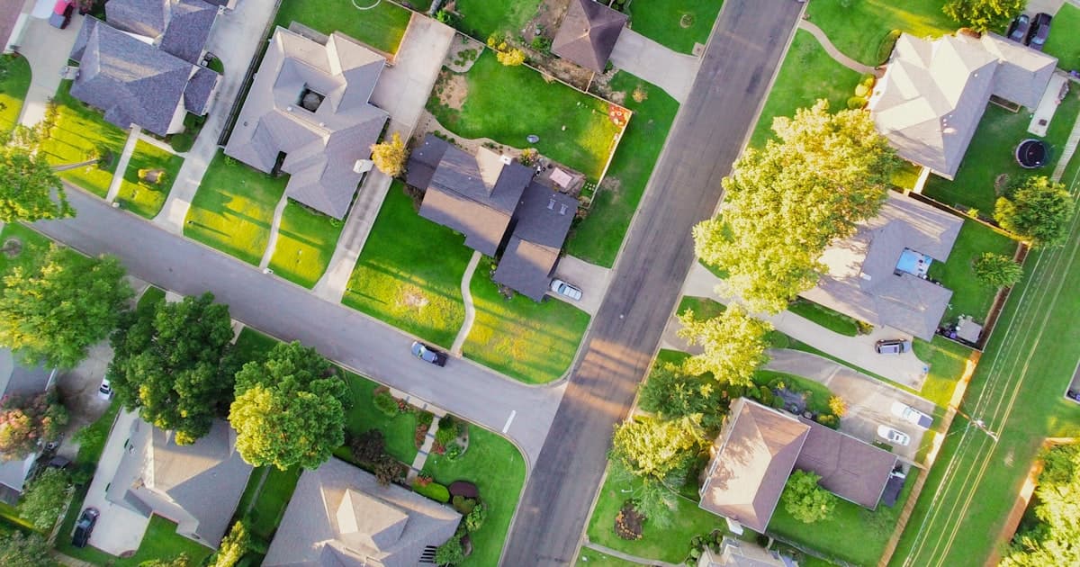 Aerial view of an American suburban neighborhood — cost of living by state, 2026