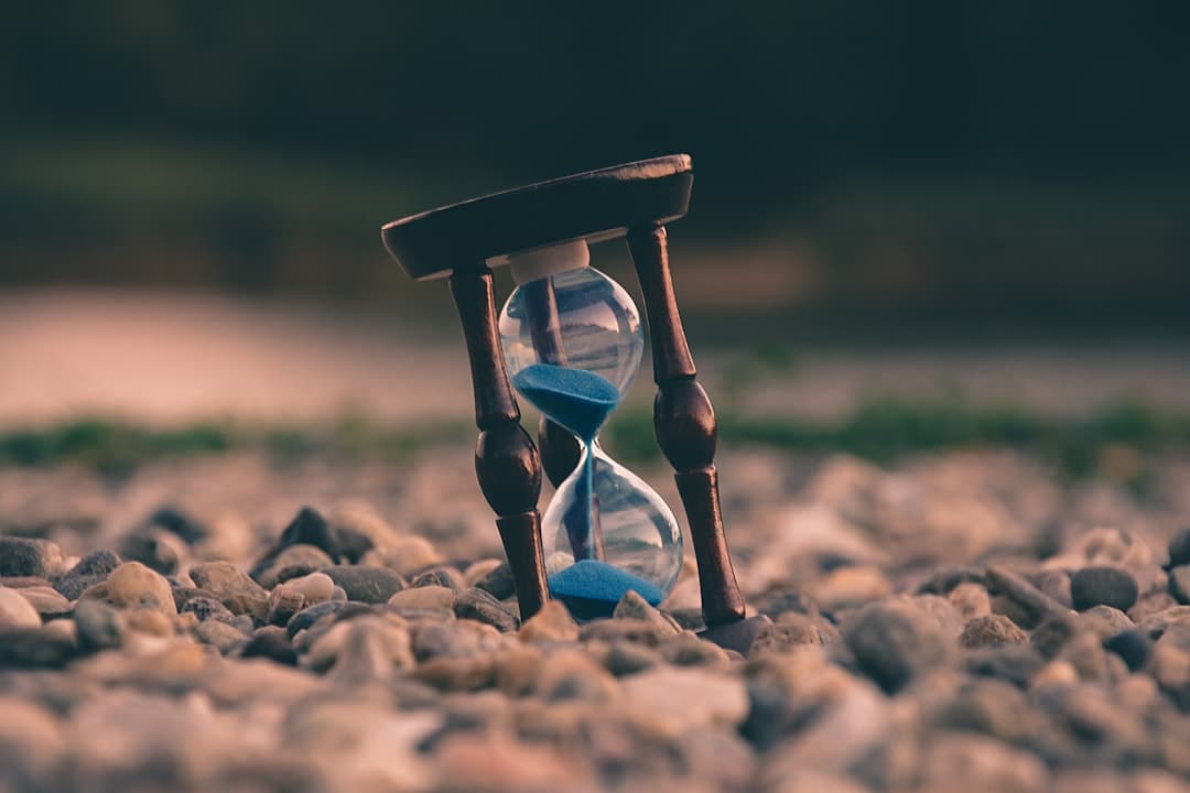 Hourglass representing the global death clock and real-time mortality statistics tracked by StatsPanda
