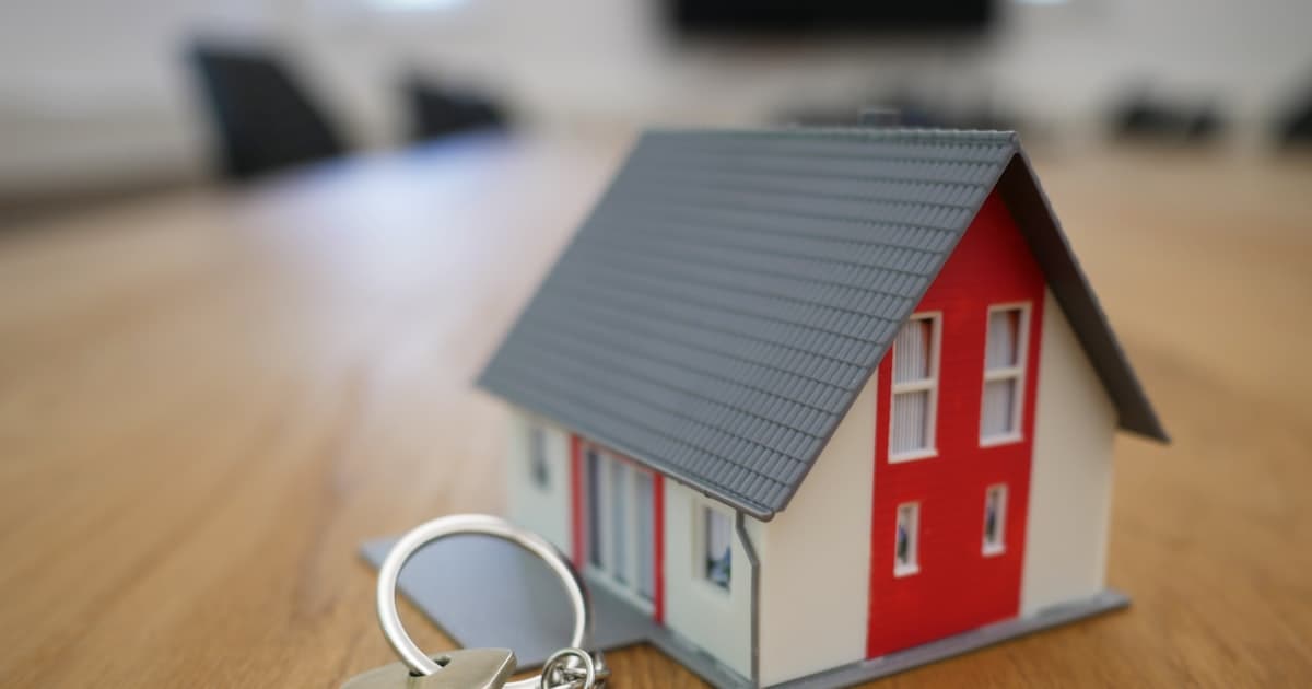A model house with a set of keys on a table — property taxes by state, 2026
